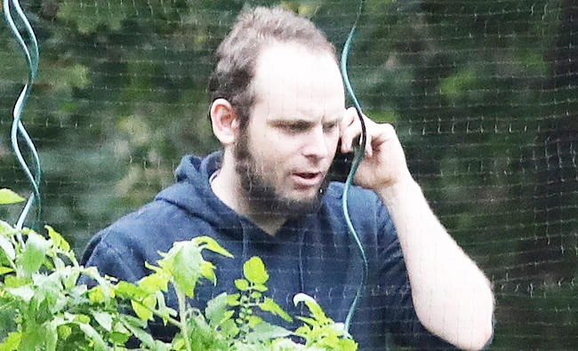 This file photo taken on October 14, 2017 shows freed Canadian hostage Joshua Boyle talking on the phone outside the Boyle family home in Smiths Falls, Ontario, Canada. (AFP)