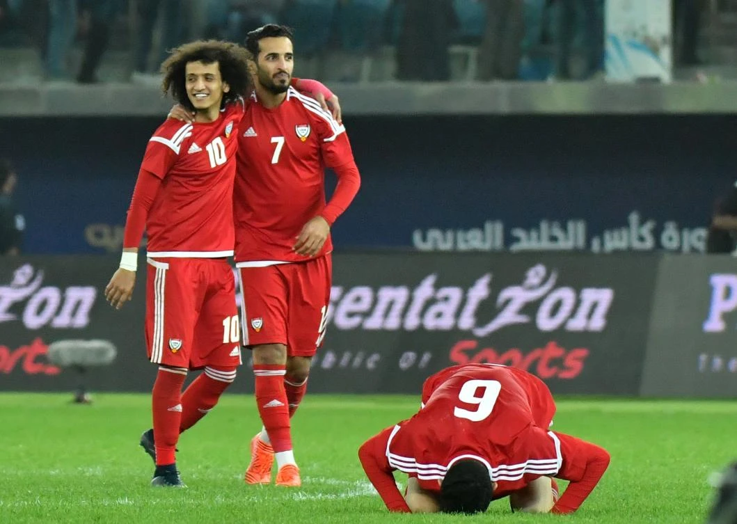 UAE's Omar Abdulrahman, Ali Mabkhout and Mohanad Salem celebrate after winning the penalty shoot-out against Iraq. (AFP)