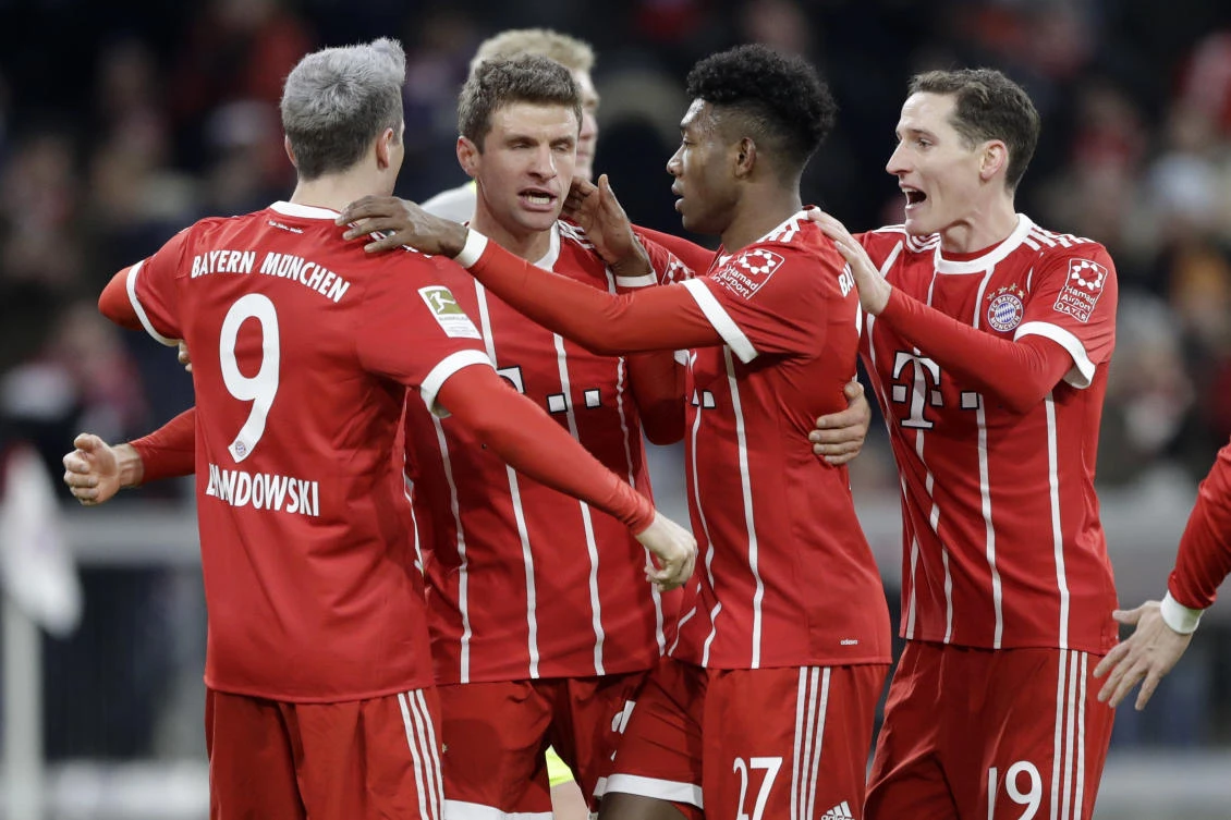 Bayern’s Robert Lewandowski , left, celebrates with team mates after scoring his side’s opening goal during the German Soccer Bundesliga match between FC Bayern Munich and 1.FC Cologne in Munich, Germany. Goals are keeping the Bundesliga exciting even if the title race has a familiar feel with Bayern Munich racing away at the halfway stage. (AP/Matthias Schrader, file)