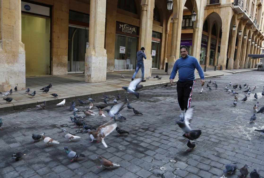 A man walks along a street in downtown Beirut, after Lebanese security forces removed roadblocks and barbed wire barriers surrounding the commercial district. (AP Photo)