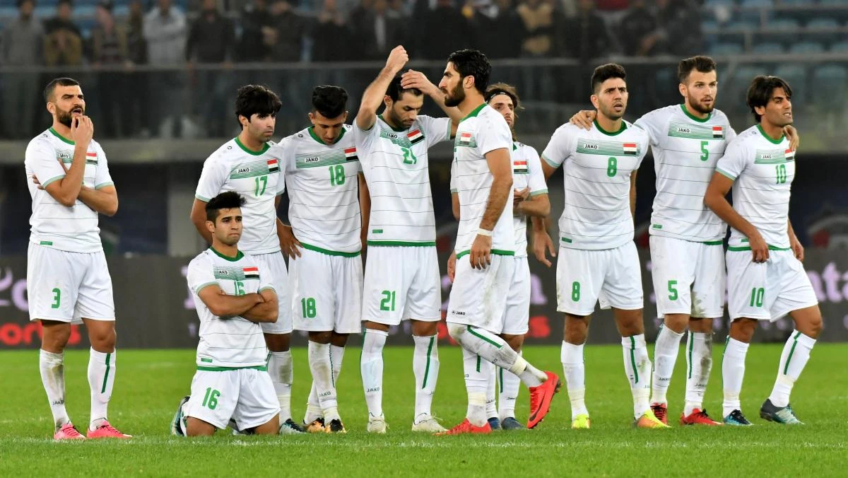Iraq players react after losing a penalty shootout to the UAE in the Gulf Cup semifinal in Kuwait. (AFP)