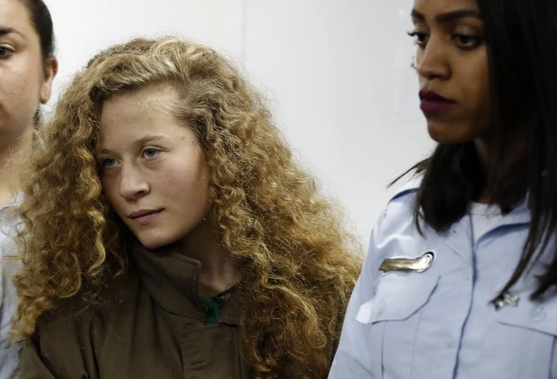 Palestinian Ahed Tamimi (C), 16-year-old prominent campaigner against Israel’s occupation, appears at a military court at the Israeli-run Ofer prison in the West Bank village of Betunia on Dec. 28, 2017. Ahed is only a teenager, but has repeatedly been at the center of the seemingly endless propaganda war between Israelis and Palestinians, with a video of her slapping soldiers the latest example. (AFP/Ahmad Gharabli)
