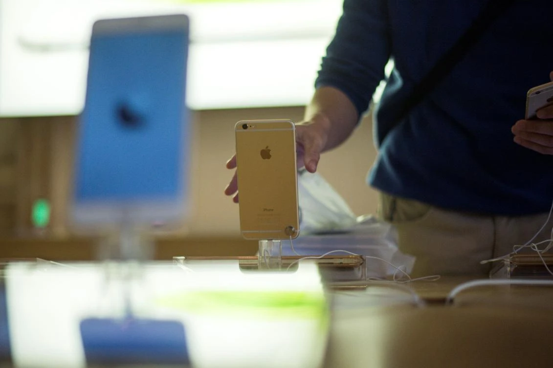 A a man checks an iPhone 6 on the day of its launch at the Apple Store in Paris. (AFP)