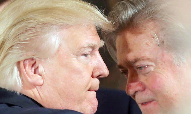 US President Donald Trump talks to chief strategist Steve Bannon during a swearing in ceremony for senior staff at the White House on Jan. 22 in this file photo. (Reuters)