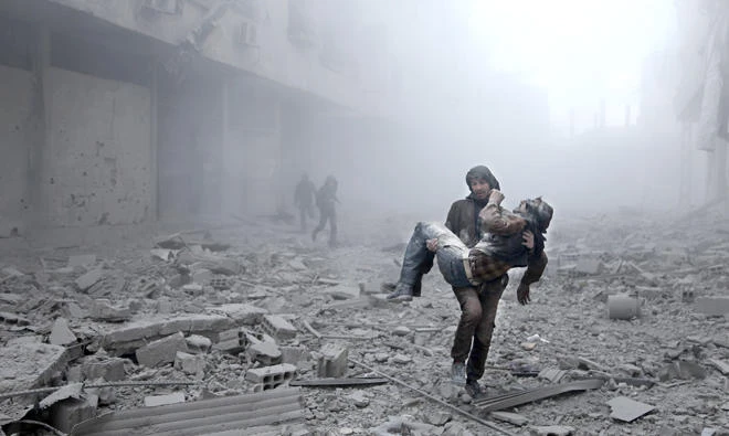 A wounded man is carried following an airstrike on the opposition-held besieged town of Arbin, in the eastern Ghouta region on the outskirts of the capital Damascus on Tuesday. (AFP)