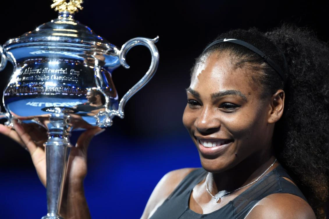 This file photo taken on January 28, 2017 shows Serena Williams of the US holding up the winner's trophy following her victory over Venus Williams of the US in the women's singles final at the Australian Open tennis tournament in Melbourne. (AFP)