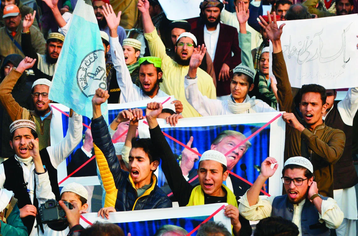 Pakistani demonstrators take part in a protest against US aid cuts in Lahore on Friday. (AFP)