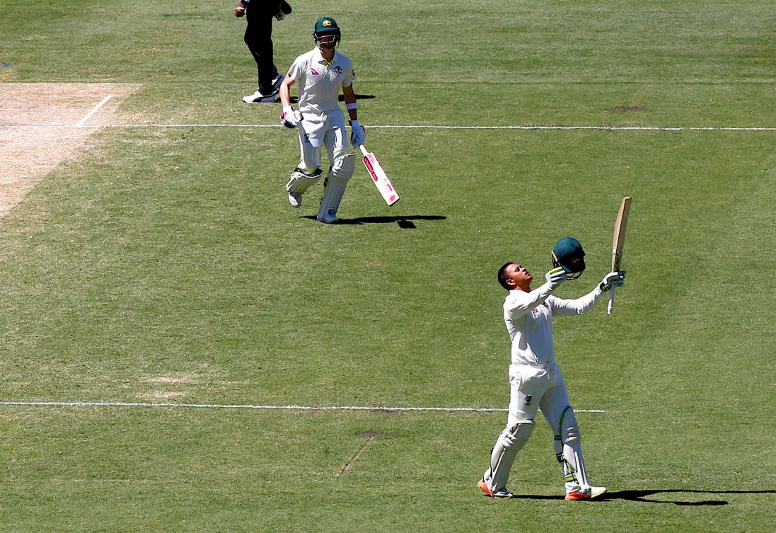 Australia's captain Steve Smith runs to congratulate team mate Usman Khawaja after he reached his century during the third day of the fifth Ashes Test in Sydney. (REUTERS)