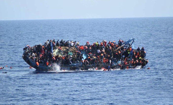 Migrants are seen on a capsizing boat before a rescue operation by Italian navy ships “Bettica” and “Bergamini” (unseen) off the coast of Libya in this handout picture released by the Italian Marina Militare on May 25, 2016. (File photo: Marina Militare/Handout via Reuters)