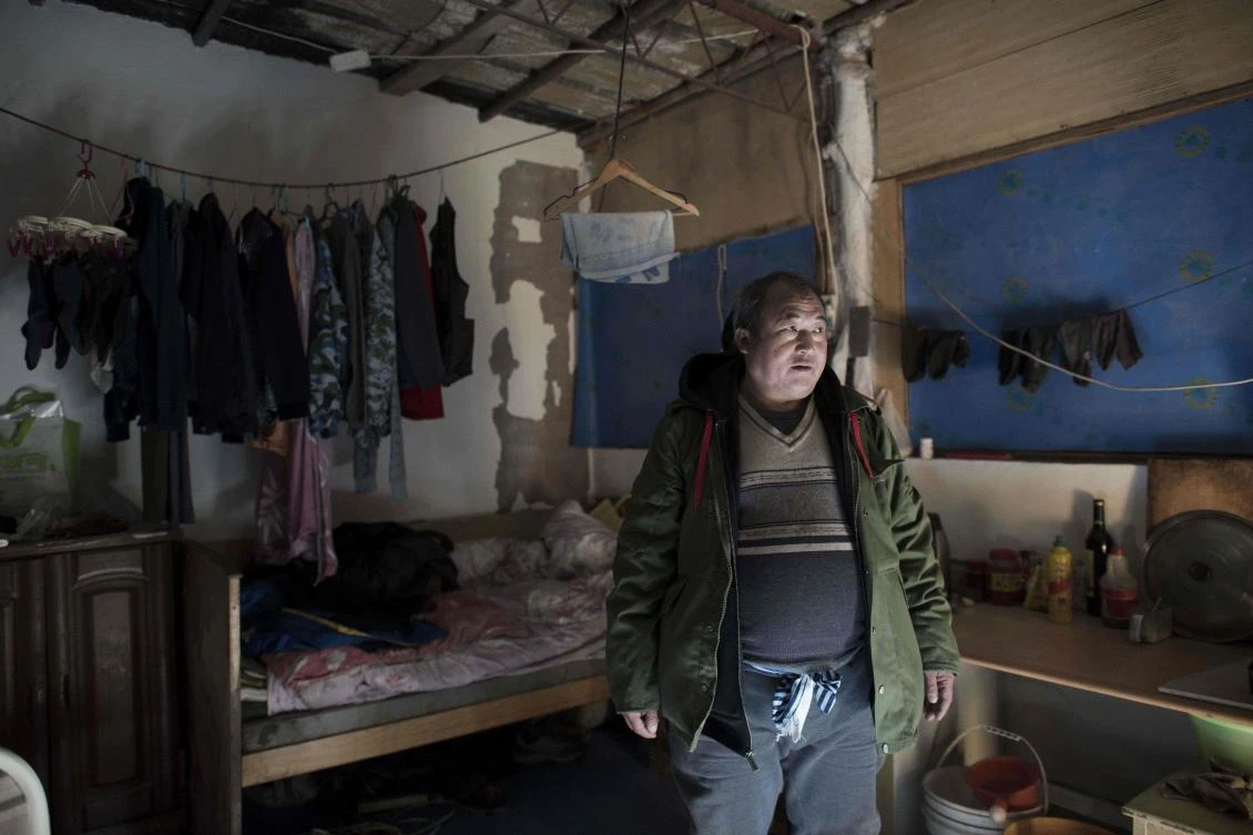 The 50-year-old Lin Huiqing, who works for a moving company, stands inside his cousin’s room where he now lives temporarily after he was evicted from his room at a migrant village on the outskirts of Beijing. Lin is one of hundreds of millions of migrants who moved from the countryside to the cities. (AFP)