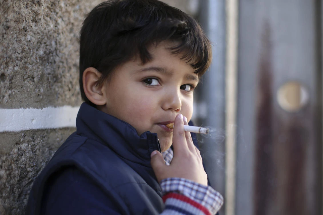 Fernando, 6-years-old, smokes a cigarette in the village of Vale de Salgueiro, northern Portugal, during the local Kings' Feast Saturday, Jan. 6, 2018. The village's Epiphany celebrations, called Kings' Feast, feature a tradition that each year causes an outcry among outsiders: parents encourage their children, some as young as 5, to smoke cigarettes. Parents buy the packs of cigarettes for their children. Locals say the practice is centuries-old, but nobody is sure what it symbolizes nor why the children are incited to smoke. (AP)