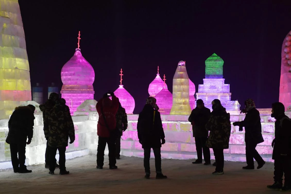 Visitors look at ice sculptures on the opening day of the annual Harbin Ice and Snow Sculpture Festival in Harbin, northeast China. A combination of tighter capital controls and a faltering dollar helped the yuan stage a strong turnaround, bolstering confidence in the economy. (AFP)