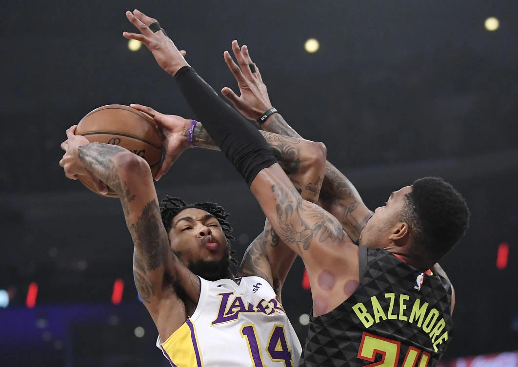 Los Angeles Lakers forward Brandon Ingram, left, shoots as Atlanta Hawks guard Kent Bazemore defends during their NBA game on Sunday, January 7. (AP)