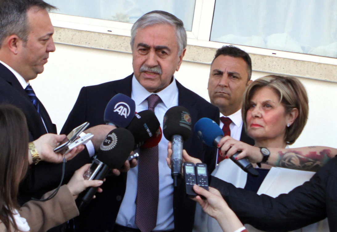 Turkish-Cypriot President Mustafa Akinci (C) speaks to the press as he arrives to cast his ballot for the parliamentary election at a polling station in the northern part of Nicosia in the self-proclaimed Turkish Republic of Northern Cyprus (TRNC), which is only recognized by Turkey, on January 7, 2018. (AFP)