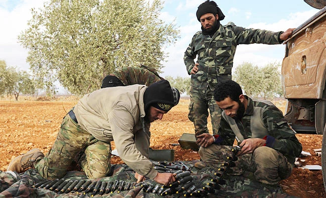 Opposition fighters prepare ammunition in the al-Mushrifa area, near the town of Khan Sheikun in Syria's northwestern rebel-held province of Idlib, during ongoing clashes with government forces, in this January 2, 2018 photo. (AFP)