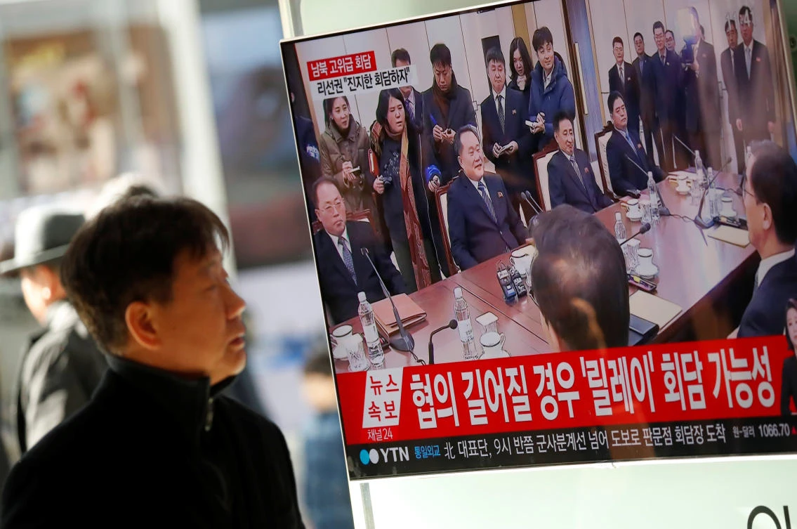 A man watches a TV broadcasting a news report on a high-level talks between the two Koreas at the truce village of Panmunjom, in Seoul, South Korea, January 9, 2018. (Reuters)