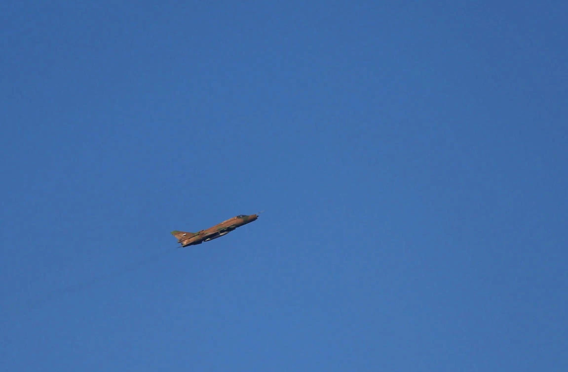 A Syrian government plane flies over the rebel-held besieged town of Arbin, in the eastern Ghouta region on the outskirts of the capital Damascus on Jan. 8, 2018. (AFP/Amer Almohibany)
