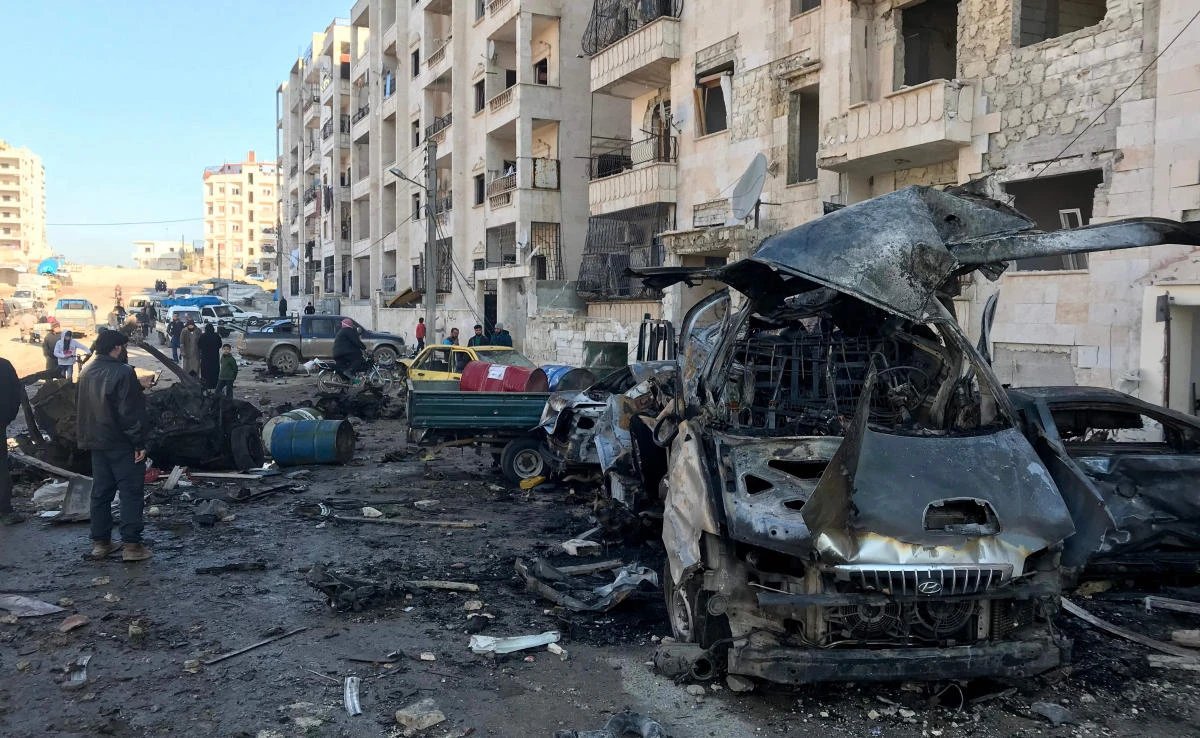 People look at the damage in the aftermath of an explosion in a rebel-held area of the northwestern Syrian city of Idlib on Jan. 8, 2018. (AFP)