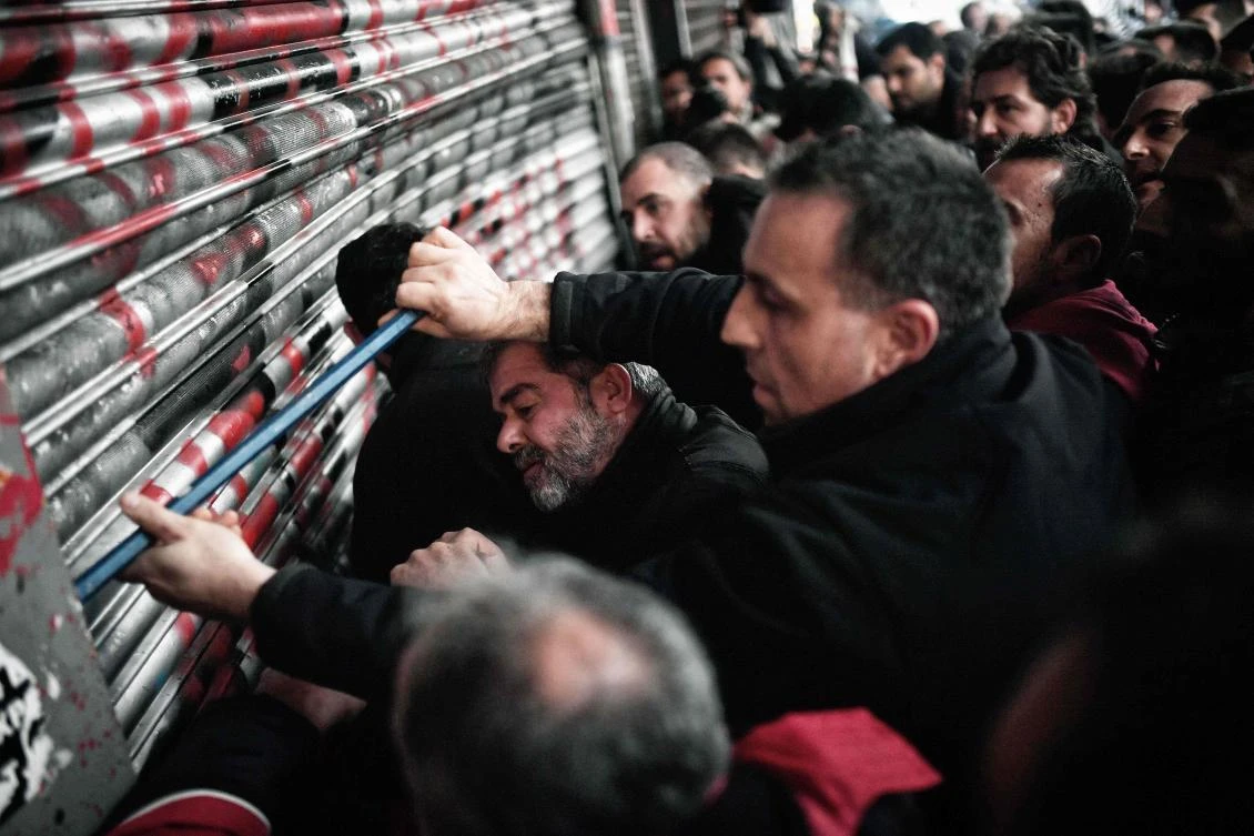 Communist-affiliated PAME workers unionists break into the Ministry of Labour in Athens, during a protest against a law submited to the parliament which includes strike restrictions as part of the Greek austerity measures. (AFP)