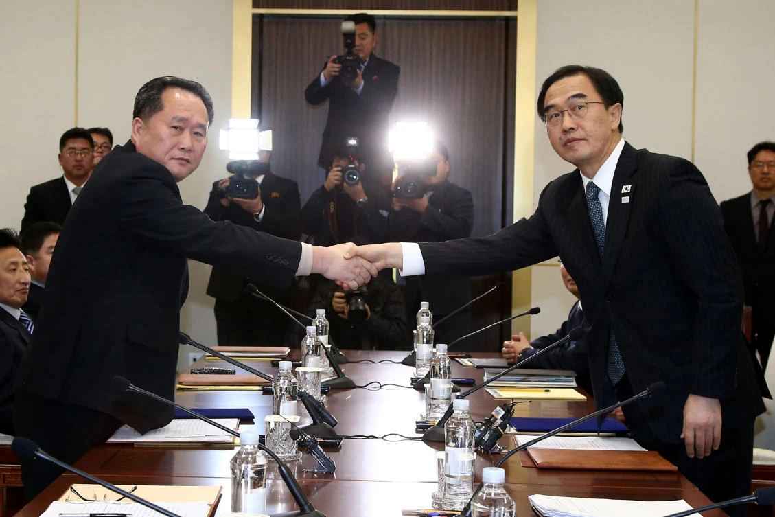 South Korean Unification Minister Cho Myoung-gyon, right, shakes hands with the head of North Korean delegation Ri Son Gwon during their meeting at the Panmunjom in the Demilitarized Zone in Paju on January 9. South Korean President Moon Jae-in has previously floated the idea of a summit with his Kim Jong un under conditions. (Korea Pool via AP)