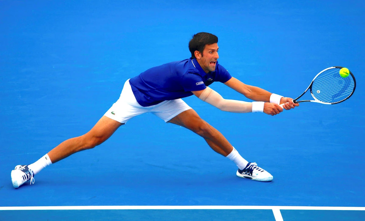 Serbia’s Novak Djokovic stretches to hit a shot during his match against Austria’s Dominic Thiem at Kooyong Classic in Melbourne. Djokovic dominated the fifth-ranked Thiem 6-1, 6-4 in the key tune-up event for next week’s Australian Open. (Reuters)