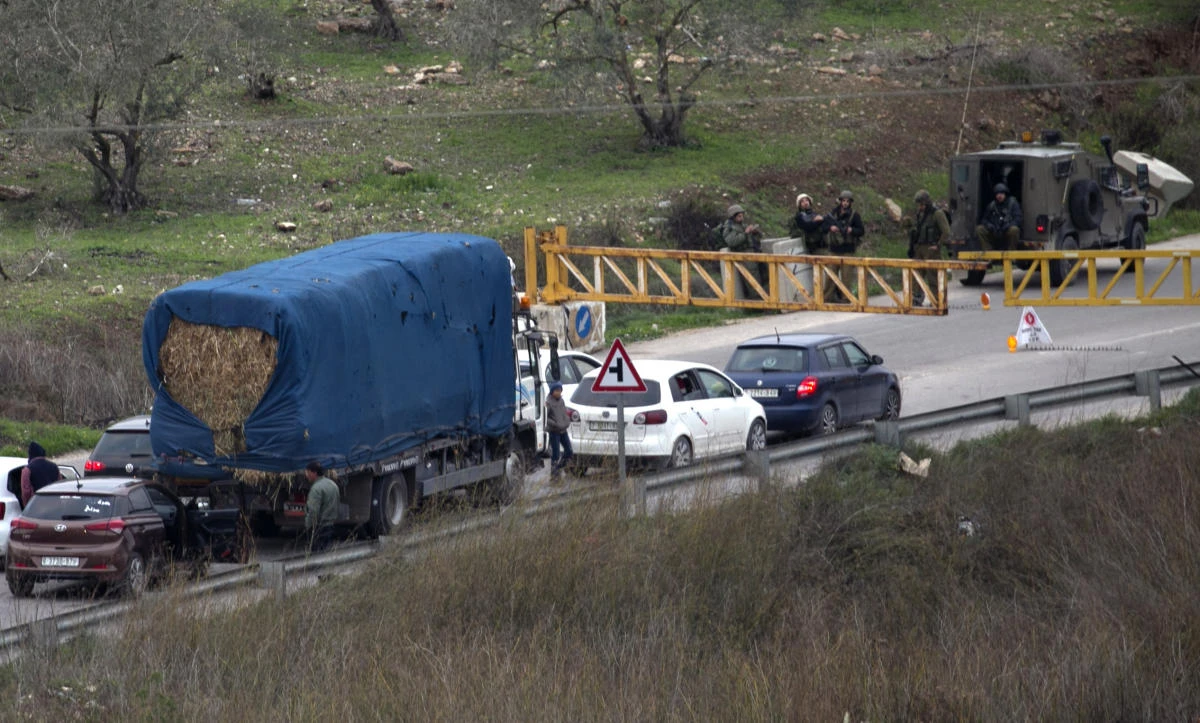 Israeli forces man a roadblock on Jan. 10, 2018 in the area where a 35-year-old Israeli rabbi was killed late the previous day while driving near the wildcat settlement where he lived, around the West Bank village of Jit near Nablus. Israeli forces set up roadblocks and deployed around a major Palestinian city in the occupied West Bank in a manhunt for a gunman who shot dead an Israeli settler. Raziel Shevah. Some 22 gunshots were found in his car, Israel’s army radio reported. The gunshots reportedly came from a passing vehicle. (AFP/Jaafar Ashtiyeh)