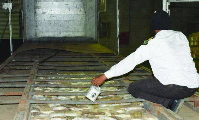 Saudi Customs officers display confiscated drugs found in a truck at Diba Port. (File photo: SPA)