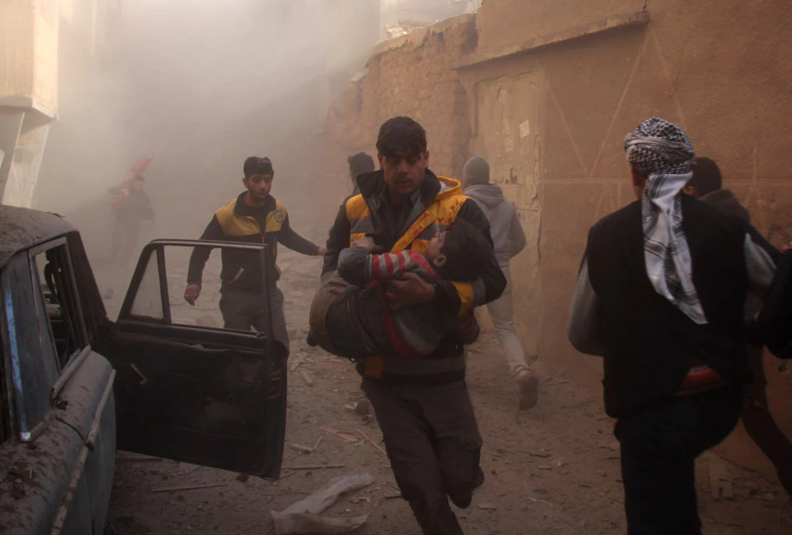 Members of the Syrian civil defense (known as the White helmets) evacuate wounded people in the rebel-held besieged town of Douma following air strikes on the outskirts of the capital Damascus. Regime forces upped the pressure on two of the last rebel bastions in Syria, pounding the Eastern Ghouta enclave and the northern province of Idlib. (AFP)