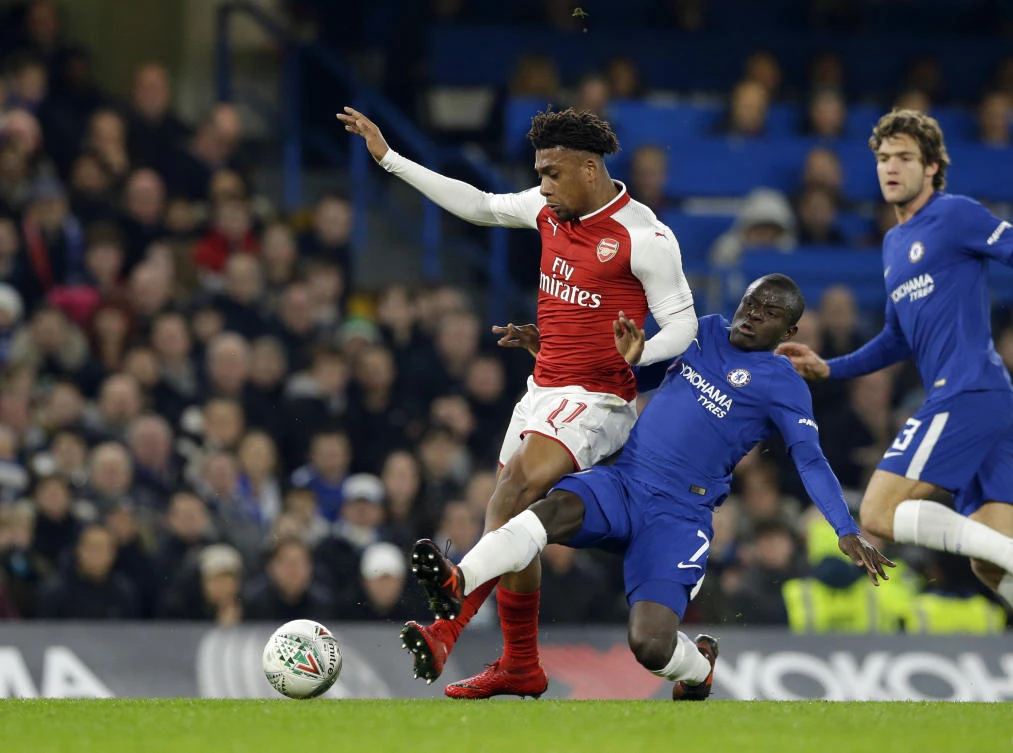 Arsenal's Alex Iwobi, left, challenges for the ball with Chelsea's N'golo Kante. (AP)