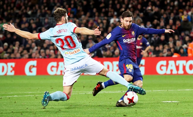 Barcelona ace Lionel Messi evades a tackle from Celta Vigo's Sergi Gomez. (Reuters)