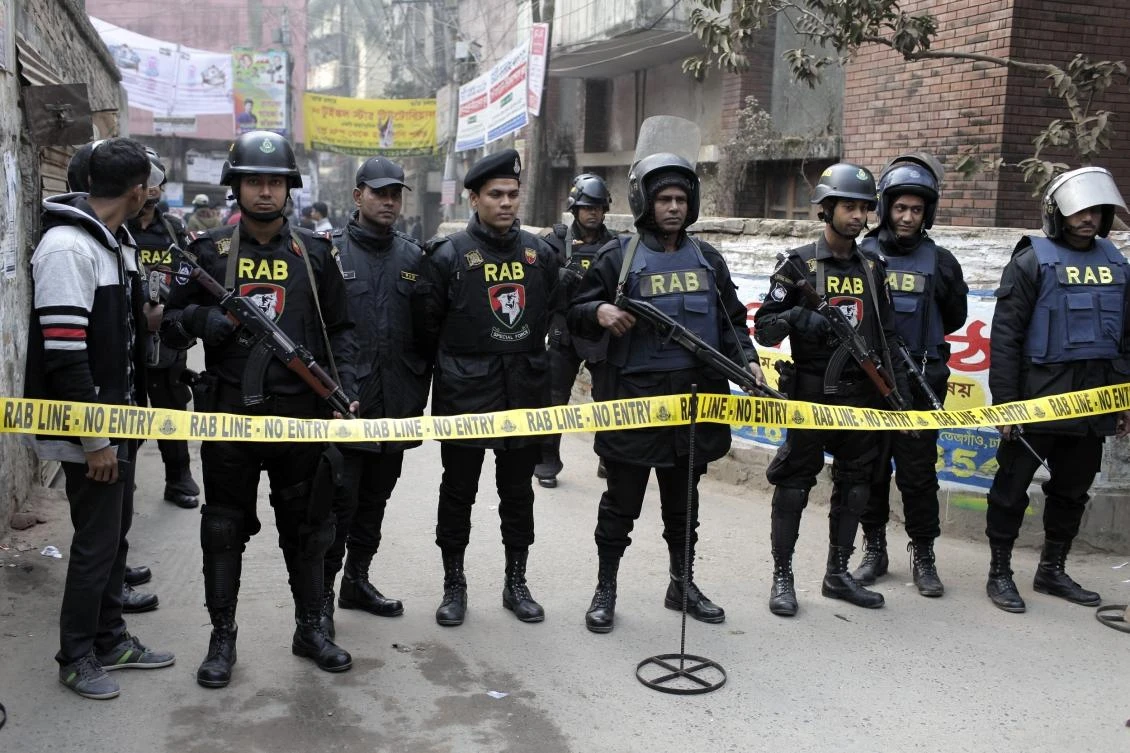Members of Rapid Action Battalion guard a street during an operation in Dhaka, Bangladesh. Three suspected Muslim militants have been killed inside a building near the office of Prime Minister Sheikh Hasina. (AP)
