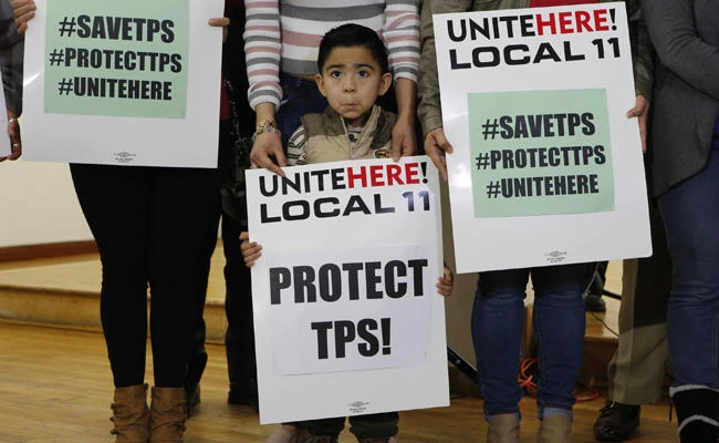 In this Jan. 8, 2018 photo, Mateo Barrera, 4 originally from El Salvador, whose family members benefit from Temporary Protected Status, TPS, attends a news conference in Los Angeles. (AP Photo/Damian Dovarganes)