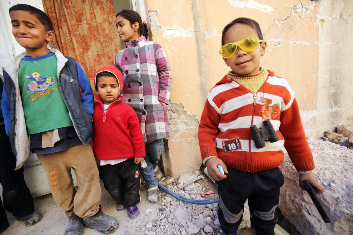 Children play in a debris-strewn alleyway in Mosul. (AFP)