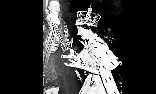 Queen Elizabeth II wearing the bejeweled Imperial crown leaves Westminster Abbey, London, on June 2, 1953. (AP)
