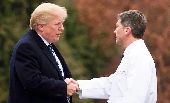 US President Donald Trump shakes hands with White House Physician Rear Admiral Dr. Ronny Jackson, following his annual physical at Walter Reed National Military Medical Center in Bethesda, Maryland, on Friday. (AFP)
