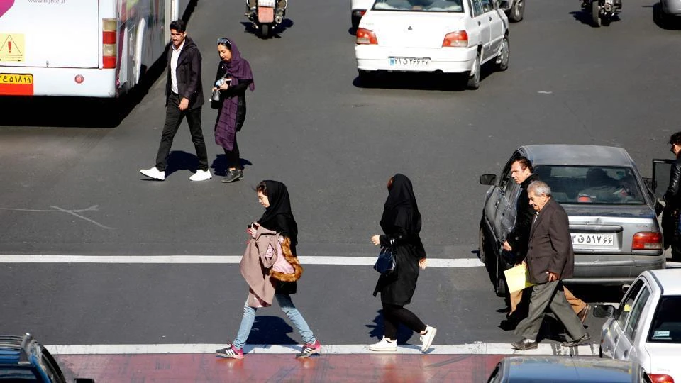 Iranian cross the road in Sadeqyeh Square in the capital Tehran on January 13, 2018. (AFP)