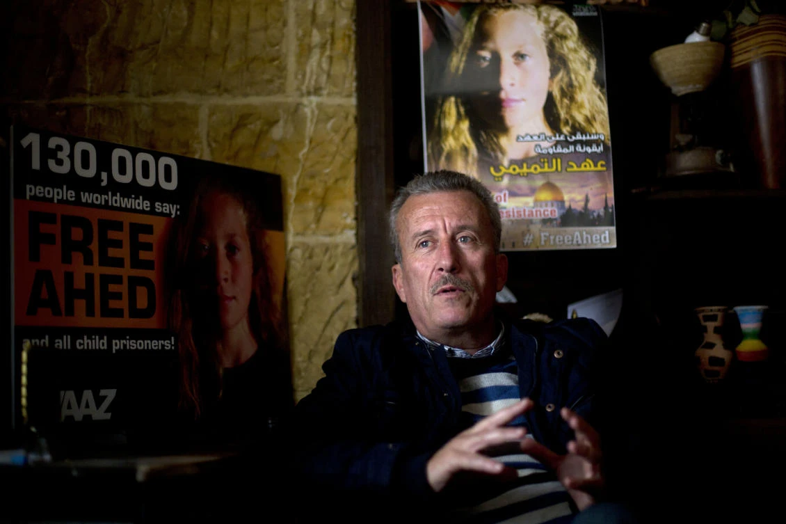 Palestinian Bassem Tamimi speaks in front of a poster showing his daughter Ahed at his home in Nabi Saleh near the West Bank city of Ramallah. Israel’s prosecution of his 16-year-old daughter who slapped two Israeli soldiers has trained a spotlight on her activist family and its role in what Palestinians call ‘popular resistance,’ or near-weekly protests against Israeli occupation staged in several West Bank villages. (AP Photo)