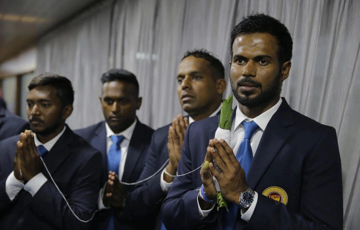 Sri Lankan cricketer Upul Tharanga, right, and his teammates take part in a religious observance before leaving for Bangladesh, in Colombo, Sri Lanka, Friday, Jan. 12, 2018. Sri Lanka will participate in the tri-nation limited overs cricket series with Bangladesh and Zimbabwe starting Jan. 15. (AP)