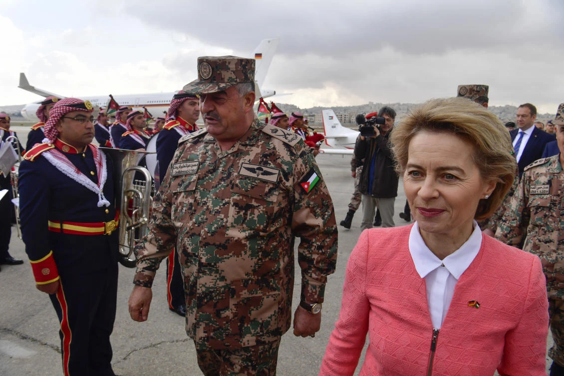 German Defense Minister Ursula von der Leyen, right, and Jordanian Chairman of the Joints Chief of Staff Mahmoud Freihat, center, attend a ceremony handing over equipment to Jordan, at Marka airport, Amman, Jordan, Sunday, Jan. 14, 2018. Germany’s defense minister handed over handed over 70 Mercedes trucks, 56 Mercedes mini vans and two training aircraft worth a total of $22 million to the Jordanian military during a visit to the kingdom. (John MacDougall/Pool Photo via AP)