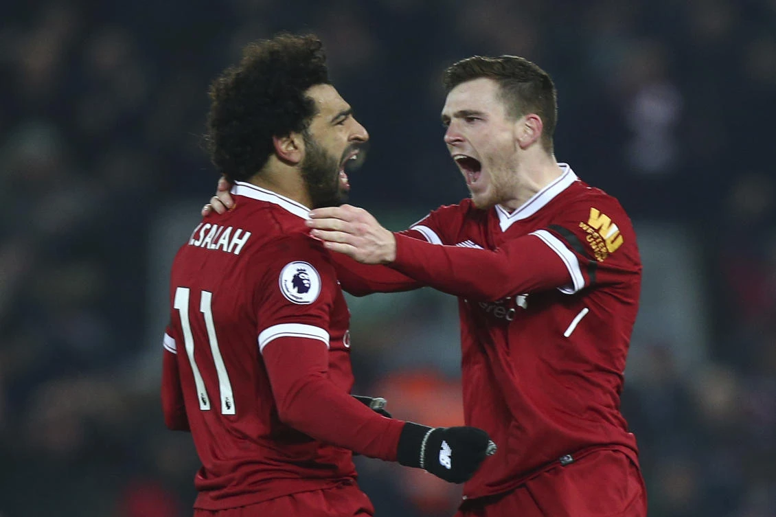 Mohamed Salah celebrates with Andrew Robertson after Salah scored Liverpool's fourth goal against Manchester City. (AP)