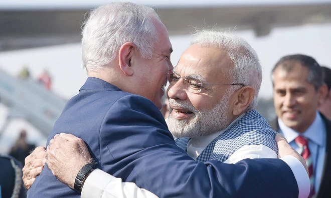 In this photograph released by the Indian Press Information Bureau on Sunday, Prime Minister Benjamin Netanyahu of Israel and his Indian counterpart Shri Narendra Modi hug each other upon Netanyahu’s arrival at Air Force Station, Palam, in New Delhi Sunday. (AFP)