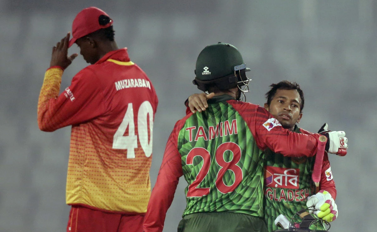 Bangladesh’s Tamim Iqbal, back to camera, hugs teammate Mushfiqur Rahim after their win over Zimbabwe in the first match of their Tri-Nation one-day international cricket series in Dhaka, Bangladesh, Monday, Jan. 15, 2018. (AP)