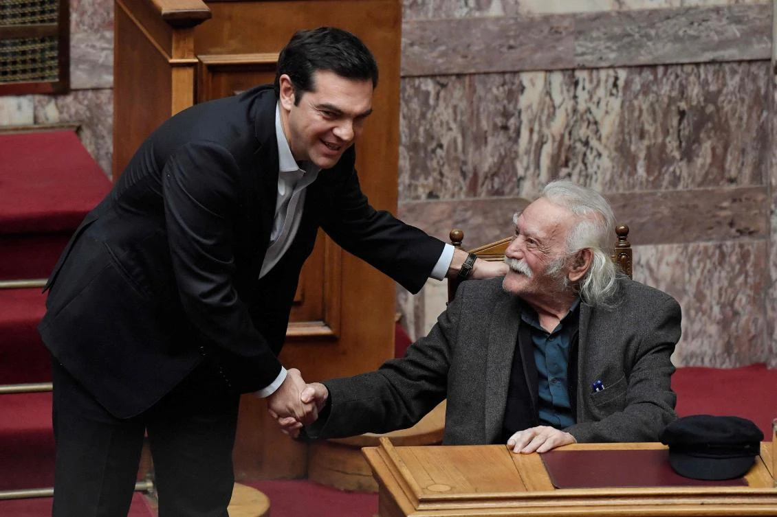 Greek Prime Minister Alexis Tsipras greets politician and resistance hero Manolis Glezos prior to a speech at the Greek parliament. The Greek leader angrily rejected criticism that his leftist administration was out to limit strikes. (AFP)