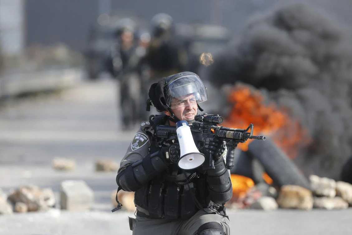 An Israeli border guard takes position during clashes following protests against U.S. President Donald Trump's decision to recognize Jerusalem as the capital of Israel, in the West Bank city of Ramallah, Friday, Jan. 12, 2018. (AP)