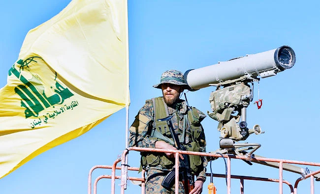 This July 29, 2017 photo, a Hezbollah fighter stands at a watchtower at the site where clashes erupted between Hezbollah and al-Qaida-linked fighters in Wadi al-Kheil or al-Kheil Valley in the Lebanon-Syria border. (AP)