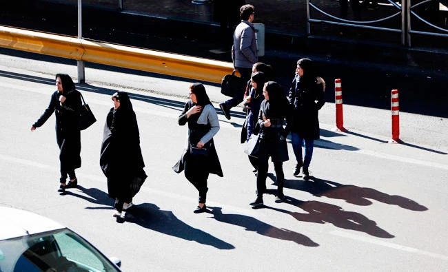 Iranian cross the road in Sadeqyeh Square in the capital Tehran on January 13, 2018. (AFP)