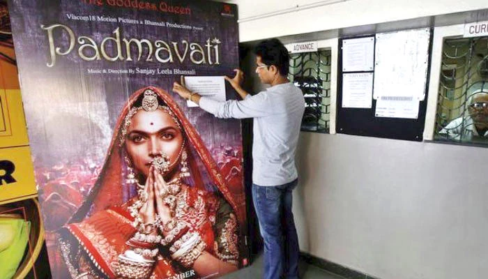 A worker adjusts a notice on a poster of ‘Padmavati’ movie at a cinema in Kolkata, India. (File photo/Reuters)
