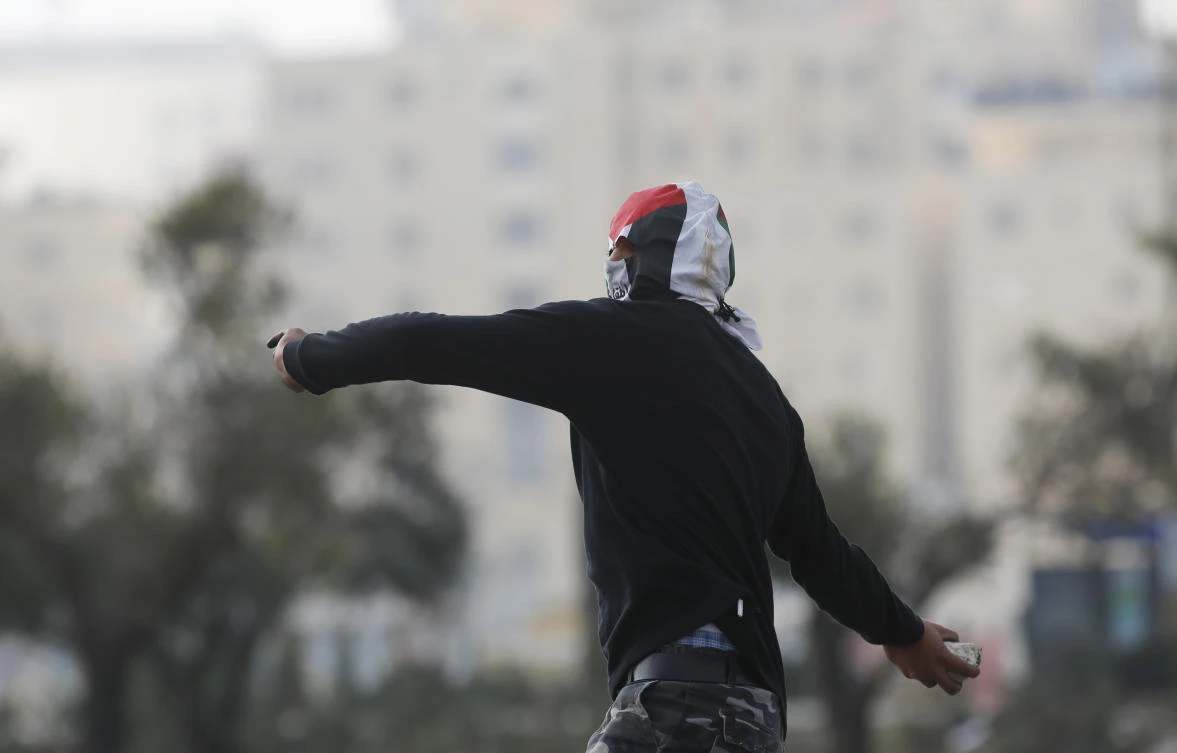 A Palestinian protester uses a slingshot during clashes following protests against US President Donald Trump's decision to recognize Jerusalem as the capital of Israel. (AP)