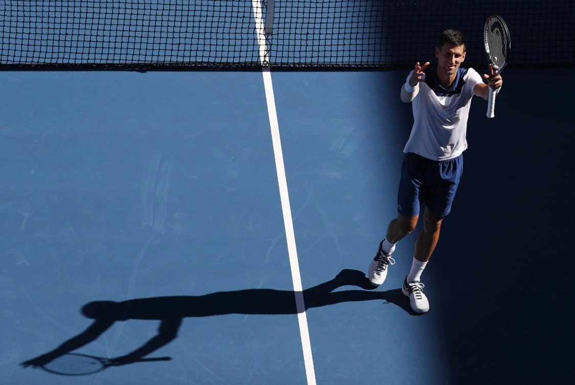 Above, Novak Djokovic of Serbia responds to the crowd after winning against Donald Young of the US, 6-1, 6-2, 6-4, during the first round of the Australian Open. (Reuters)