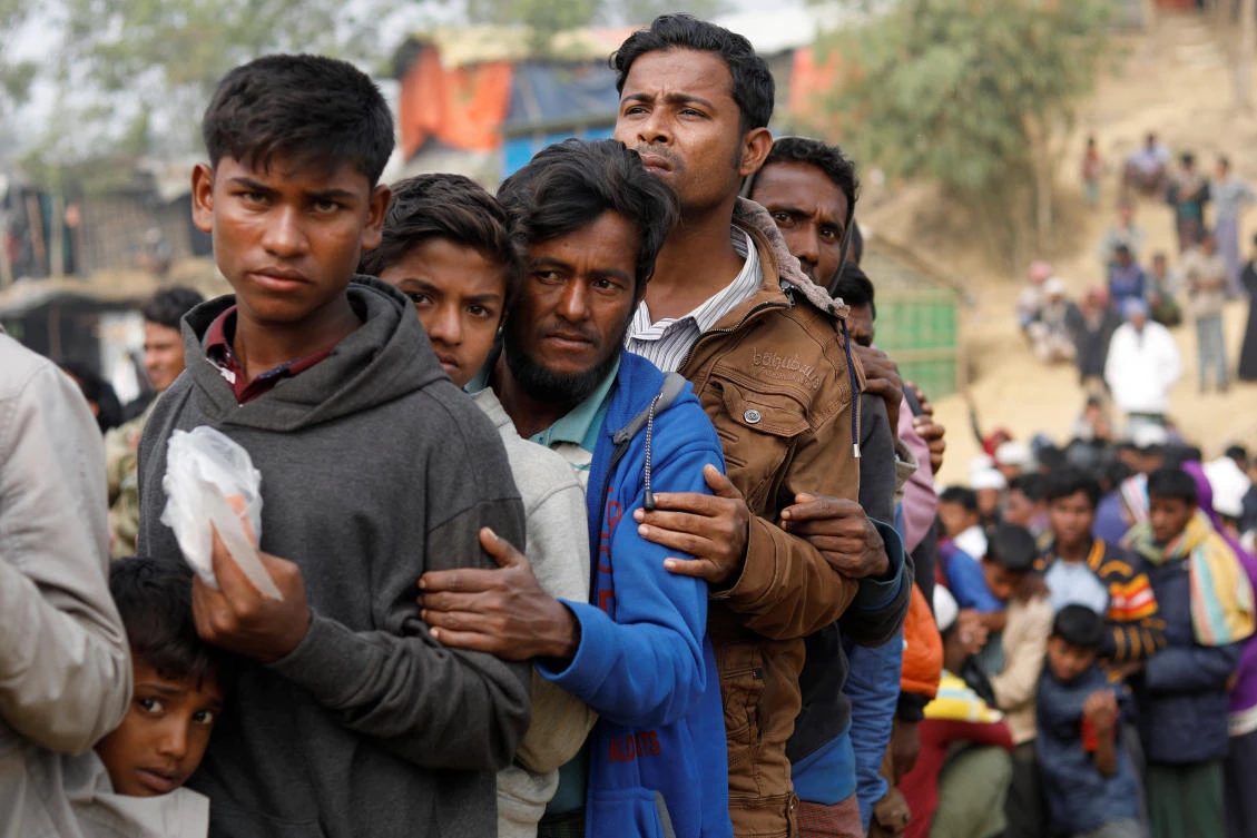 Above, Rohingya refugees line up for daily essentials distribution at Balukhali camp, near Cox's Bazar in Bangladesh on January 15. (Reuters)